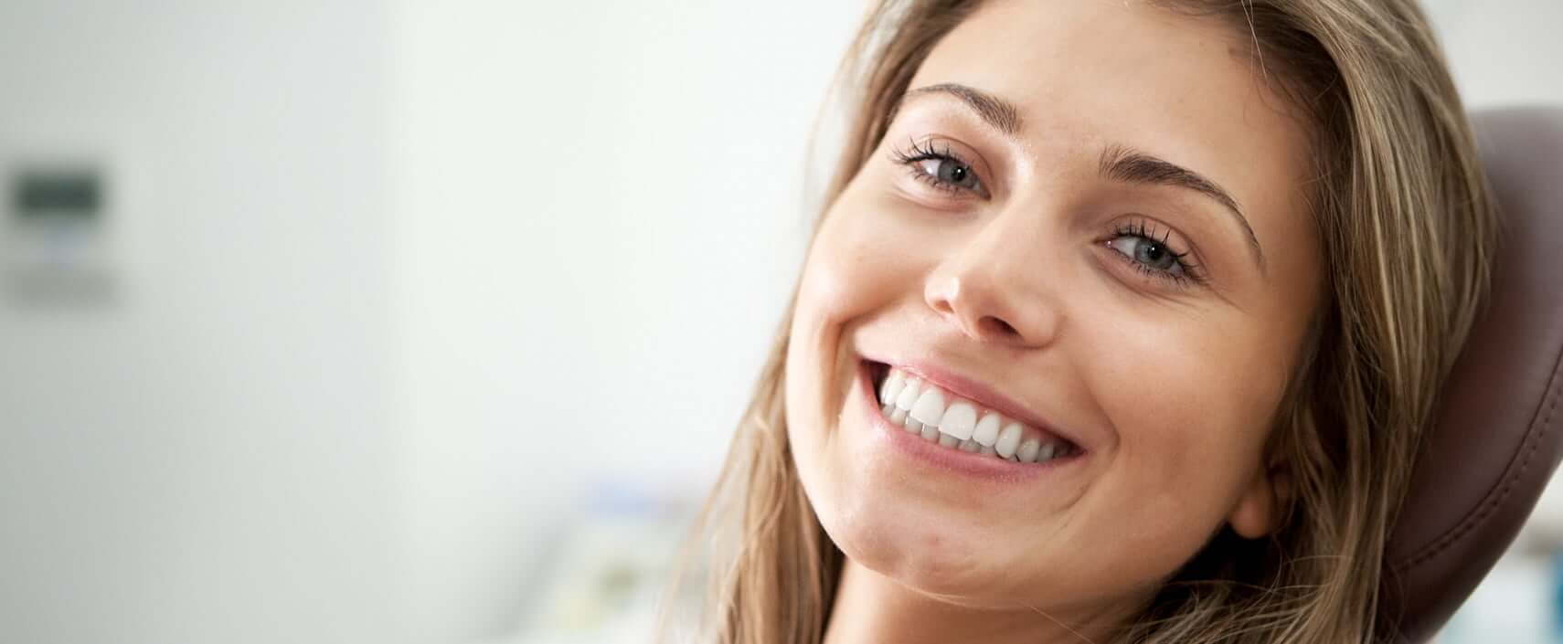 smiling woman sitting in a dental chair