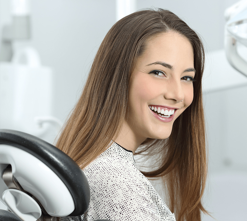 smiling woman sitting in a dental chair